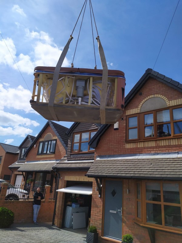 Hot Tub Move Crane Lifts a Hot Tub into a garden The Hot Tub Mover