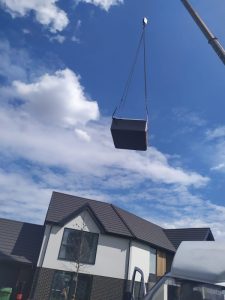 Hot Tub being lifted over a house - The Hot Tub Mover