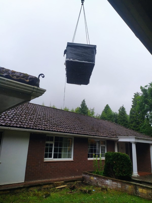 Swim Spa being lifted over a house 
